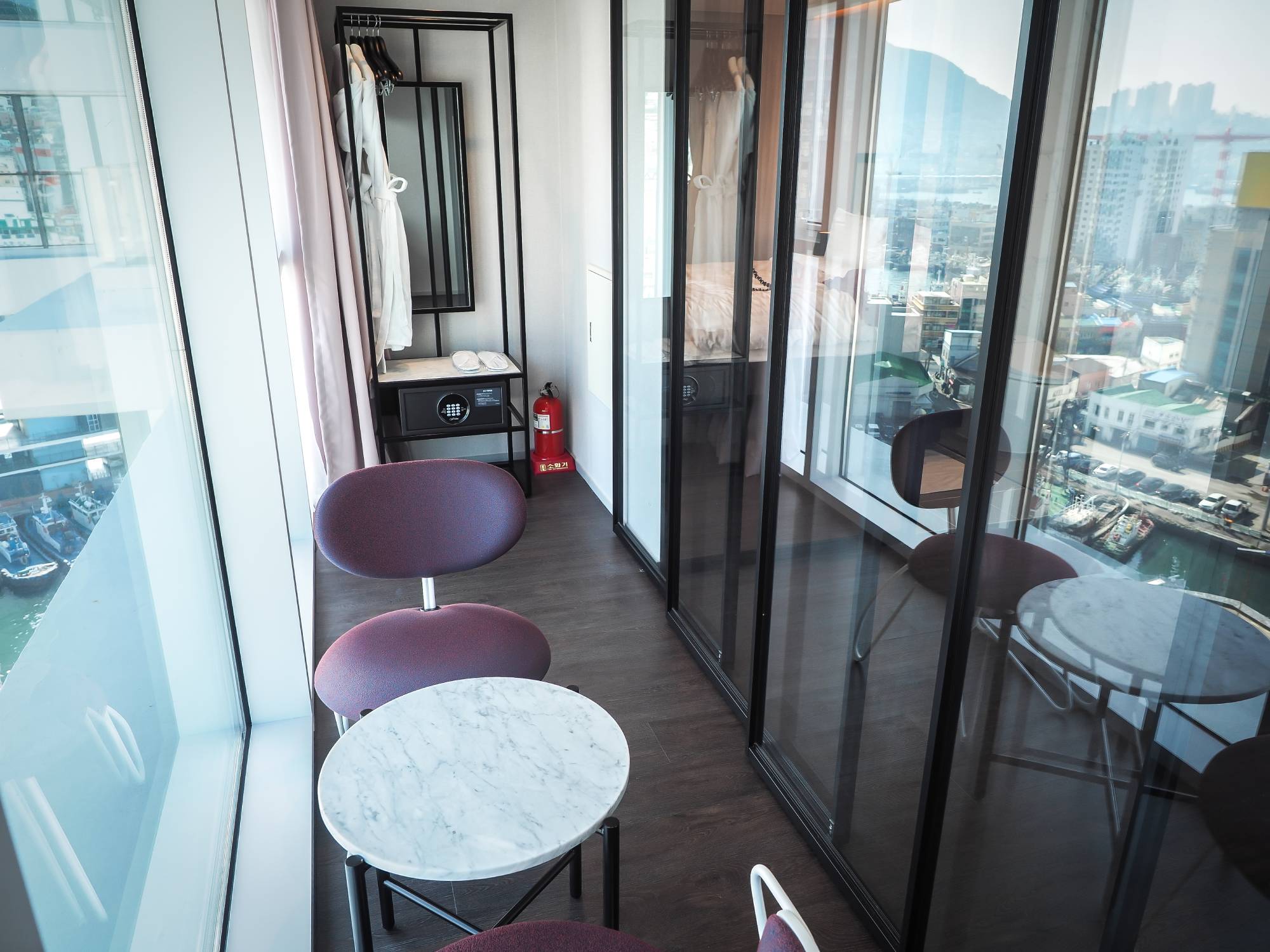 A faux balcony in my room created by a sliding glass wall, with reflections of the harbor below