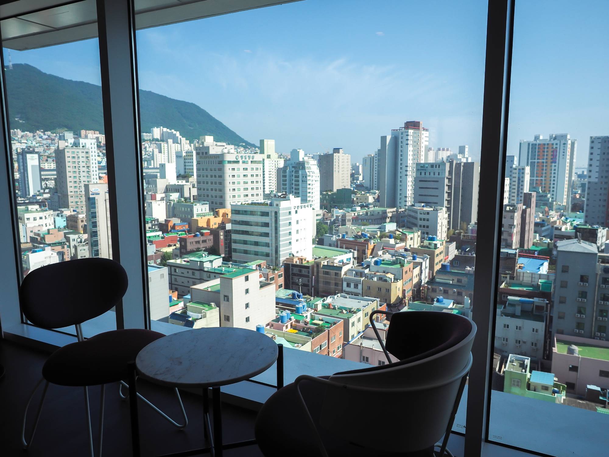 View of the buildings of Yeongdo Island and Bongnaesan Mountain, with the ocean in the background, from my room.